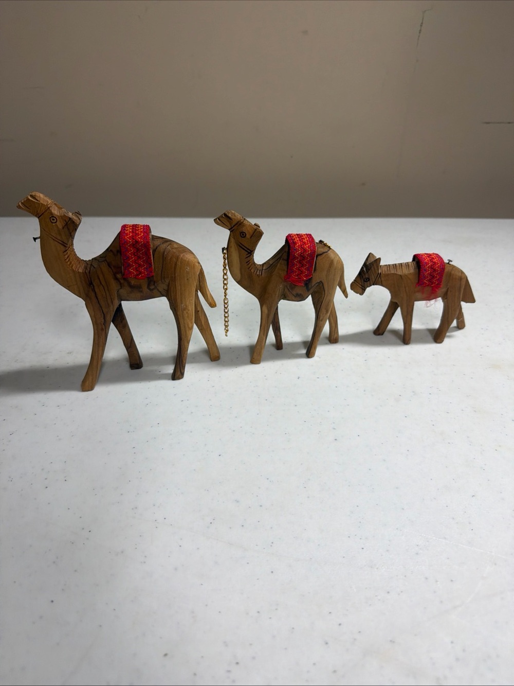 Handcarved Wooden Camel Trio with Red Saddle Accents
